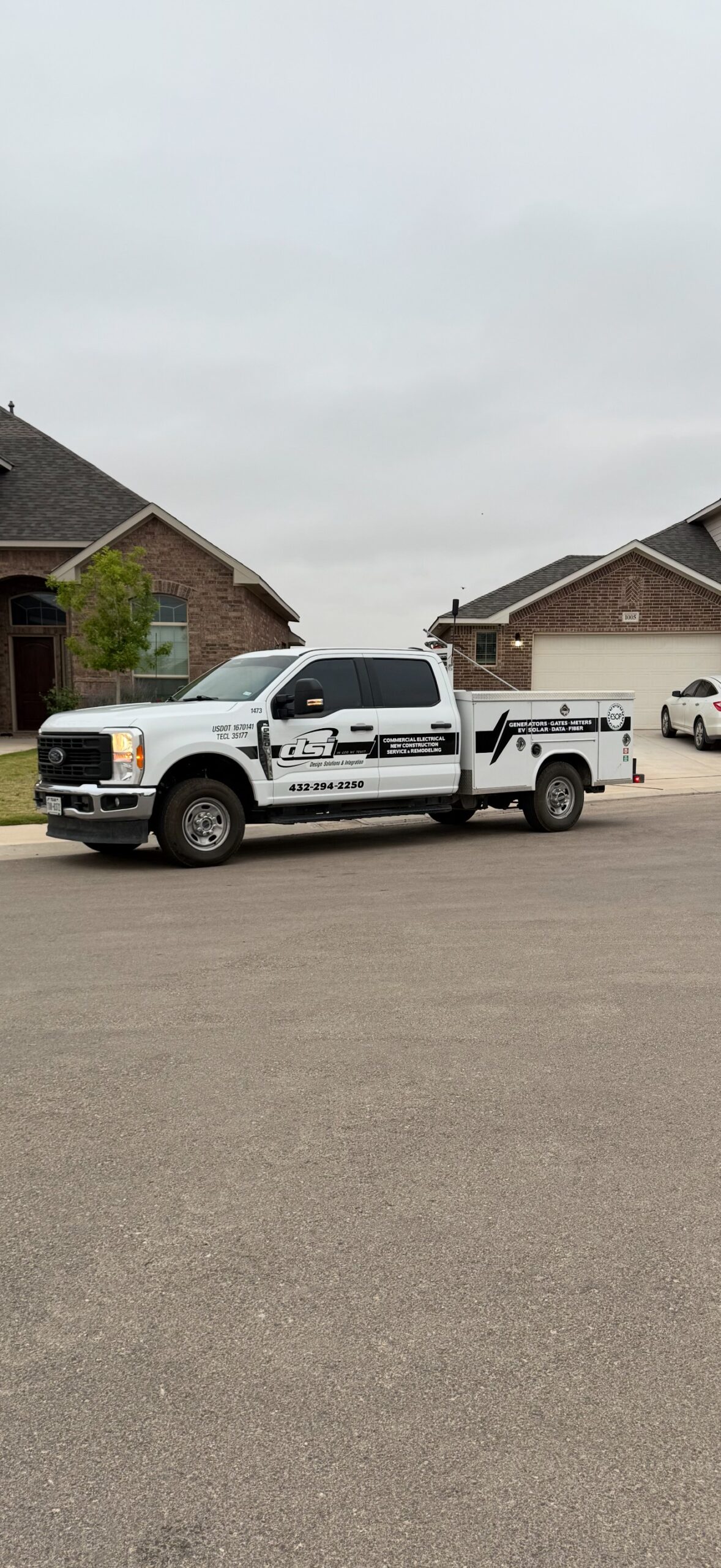 DSI Design Solutions and Integration commercial electrical service truck parked in a residential neighborhood