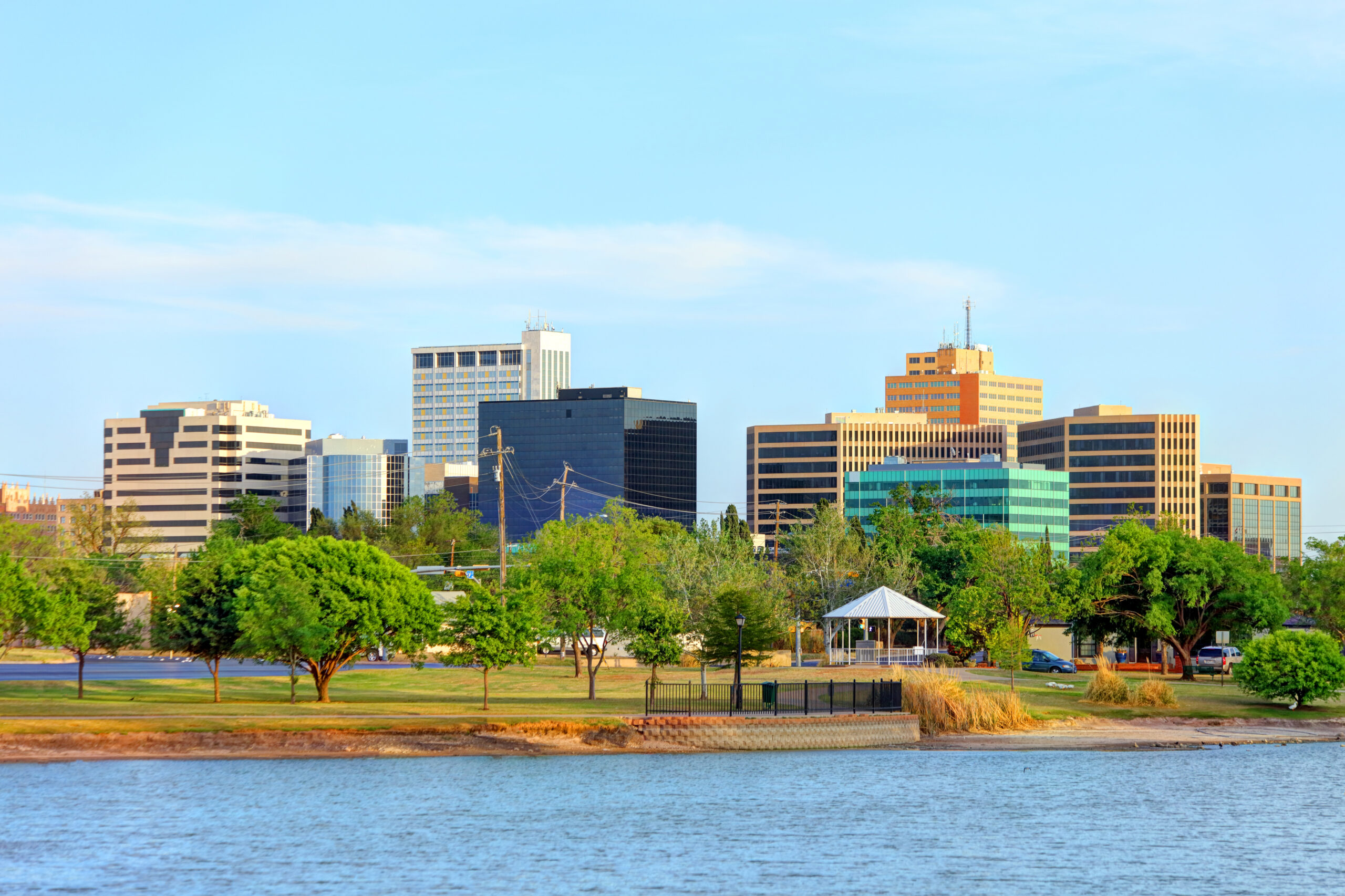 Downtown Midland, Texas skyline with office buildings beyond a riverside park