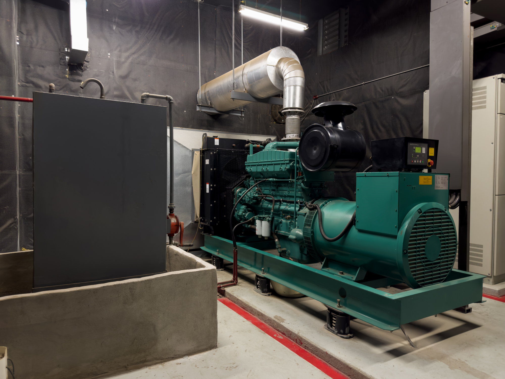 Large commercial standby generator in an indoor generator room