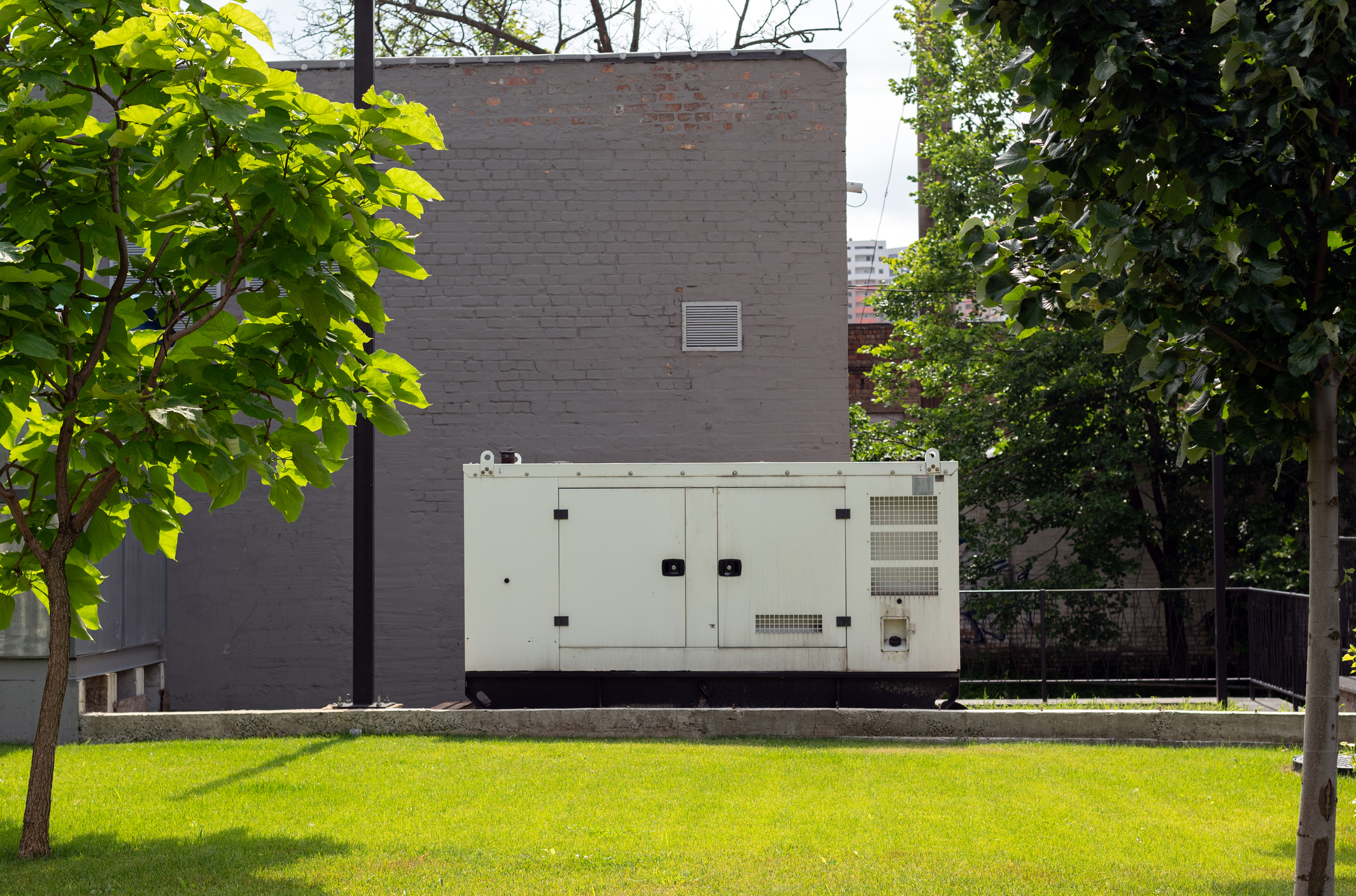 Outdoor standby generator unit beside a building