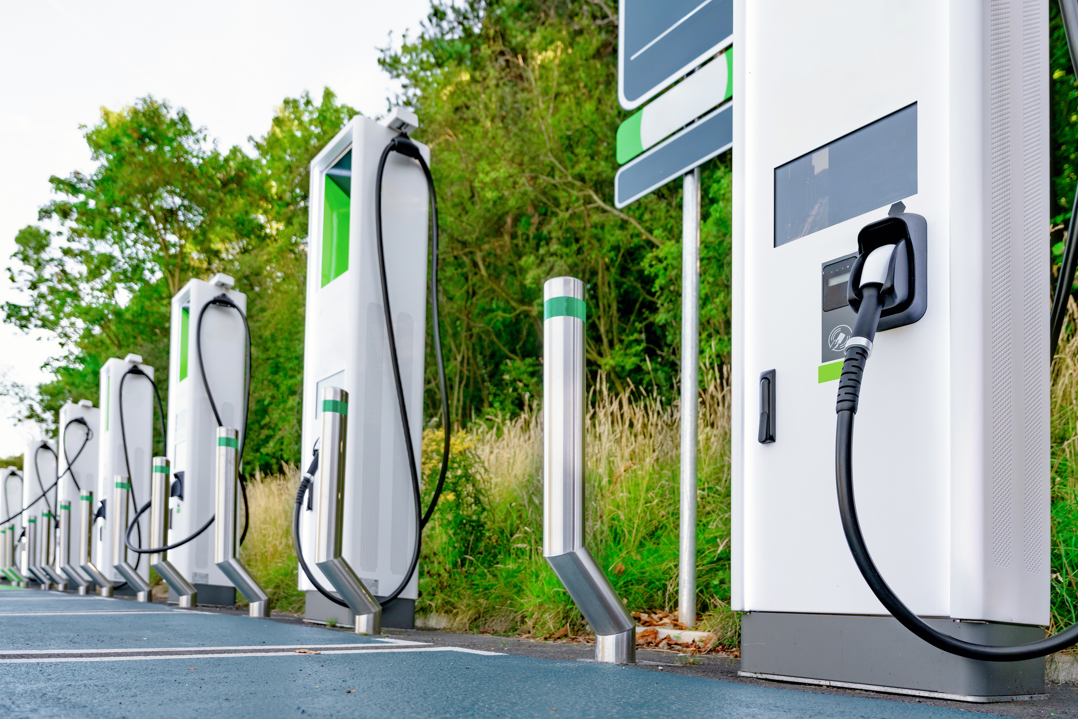 Row of EV charging station pedestals in a parking area