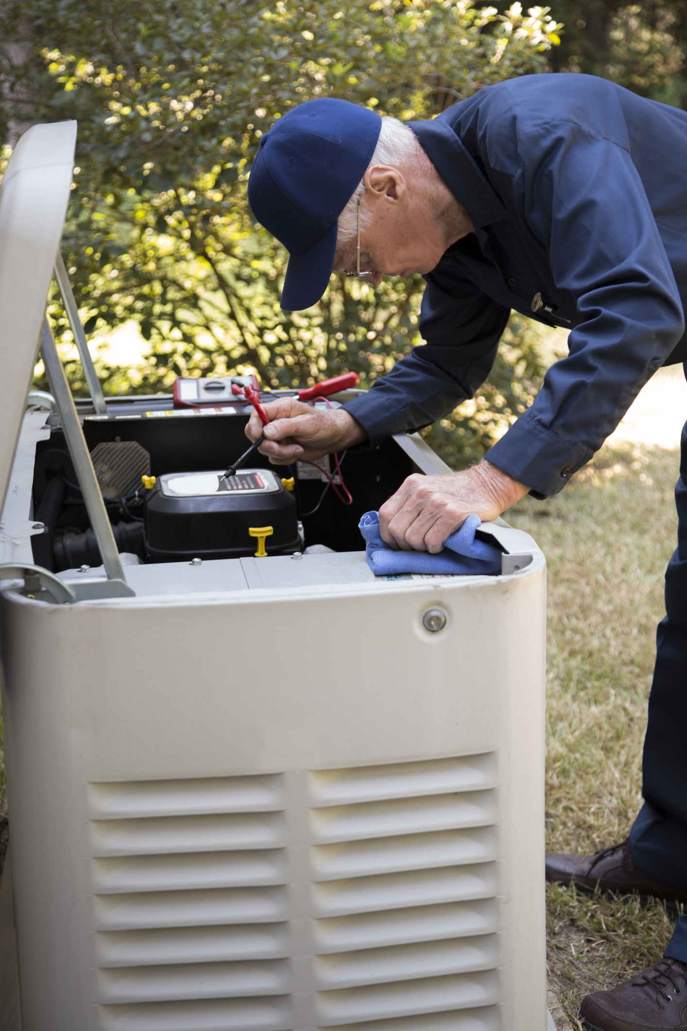Technician servicing generator and backup power equipment